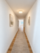 Erstbezug in Loxstedt-Nesse: Moderne 3-Zimmer-Wohnung mit überdachtem Balkon - Flur KI-Visualisierung